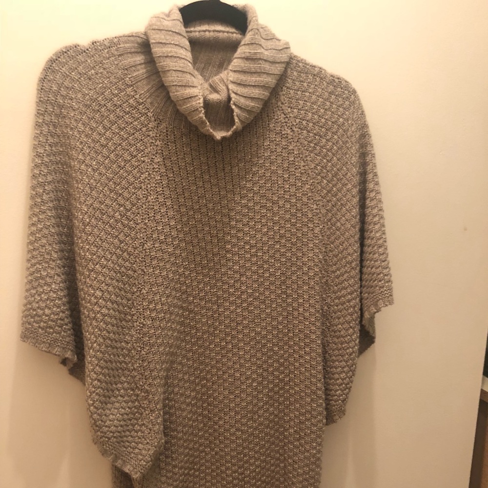 Oversized sweater; neutral color..